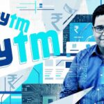 Abstract collage art featuring Vijay Shekhar Sharma and the Paytm logo, overlaid with digital circuit board patterns, rupee symbols, and QR codes in a cyan and blue color palette, representing the transition from Unicorn hype to Indicorn reality.