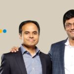 Fractal Analytics case study showing co-founders Srikanth Velamakanni and Pranay Agrawal with the corporate logo.